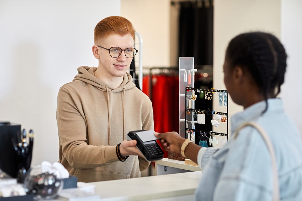 store-manager-processing-credit-card-payment-1000 store-manager-processing-credit-card-payment-1000